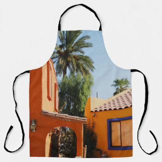 Green palm tree beside brown concrete building in apron