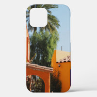Green palm tree beside brown concrete building in