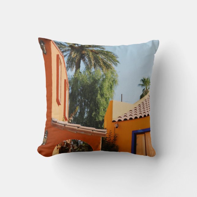 Green palm tree beside brown concrete building in  cushion (Front)