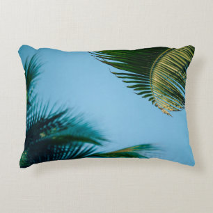 Green palm tree under blue sky in the morning decorative cushion
