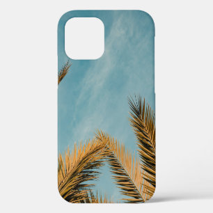 Green palm tree under blue sky in the morning iPhone 12 case