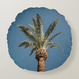 Green palm tree under blue sky in the morning round cushion