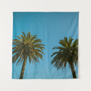 Green palm tree under blue sky in the morning tapestry