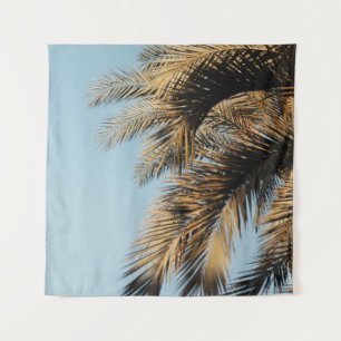 Green palm tree under blue sky in the morning tapestry
