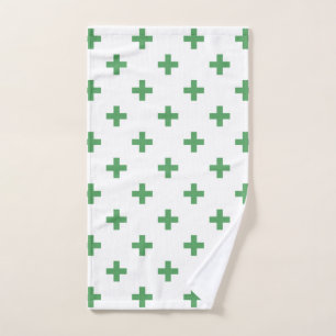 Green polka crosses on white hand towel