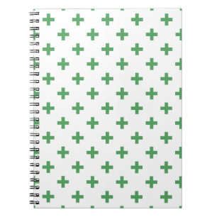 Green polka crosses on white notebook
