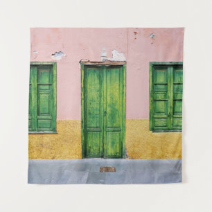 GREEN WOODEN DOOR ON WHITE CONCRETE WALL TAPESTRY