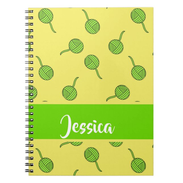 Green wool rolls on yellow notebook (Front)