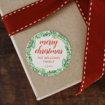 Green Wreath Merry Christmas Classic Round Sticker<br><div class="desc">Round Christmas sticker with "merry christmas" written in a red calligraphy script along with your name and the year inside a hand-drawn wreath of leaves in different shades of green with lots of small red berries.</div>