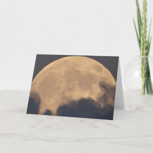 Greeting card supermoon in grey clouds
