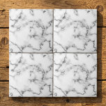 Grey and white Marble effect tile<br><div class="desc">This tile features a refined white marble design highlighted by soft grey veining. The natural marble pattern offers subtle detail and a clean, classic look that enhances both modern and traditional spaces. With a smooth, glossy finish, the tile is durable and easy to maintain—making it suitable for kitchen backsplashes, bathroom...</div>