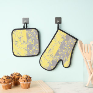 Grey and yellow leaves on a striped background. oven mitt & pot holder set