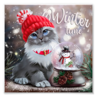 Grey cat in a red cap and a snowman in a snowball photo print