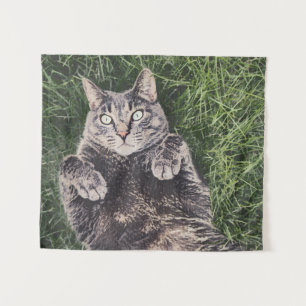 grey cat lying in the grass tapestry