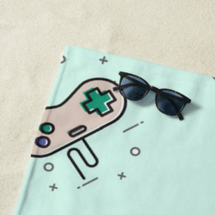 Grey game joystick on blue beach towel