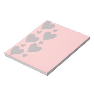 Grey hearts on a pink background notepad