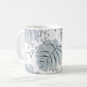 Grey monstera leaves on white coffee mug