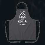 Grey Personalized King of The Grill Apron<br><div class="desc">A fun grilling apron with a bold “King of the Grill” graphic and crossed BBQ tools. Add any name under the design to make it personal. The dark background hides spills and the print has that classic backyard-BBQ vibe. Easy gift for dads, uncles, grandpas, and anyone who lives by the...</div>