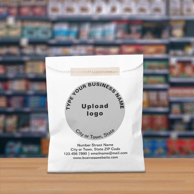 Grey Round Business Brand on Paper Bag (Paper bag with gray round business branding displayed in a store)
