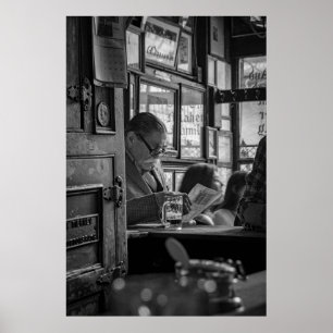 GREYSCALE PHOTO OF MAN SITTING WHILE READING NEWSP POSTER