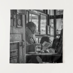 GREYSCALE PHOTO OF MAN SITTING WHILE READING NEWSP TAPESTRY