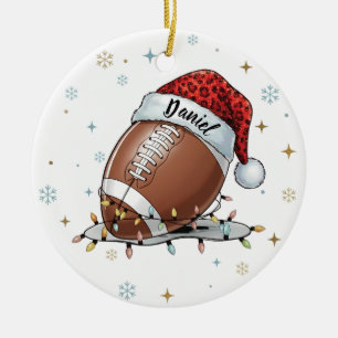 Gridiron Glow: Football with Santa Hat Ceramic Tree Decoration