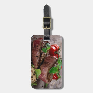 Grilled bbq steaks with fresh herbs and tomatoes luggage tag