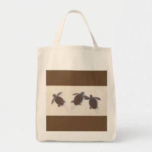 grocery bag with three baby turtles leaving tracks