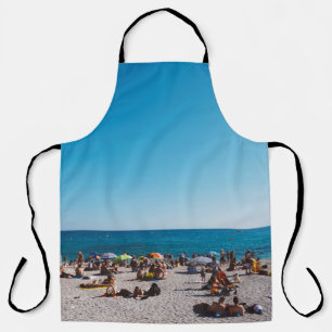 GROUP OF PEOPLE ENJOYING THE GRAY SANDED BEACH WIT APRON