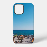 GROUP OF PEOPLE ENJOYING THE GRAY SANDED BEACH WIT