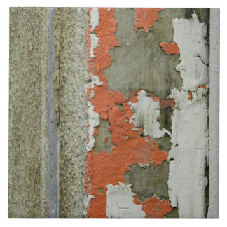 Grunge peeling orange paint on concrete wall tile