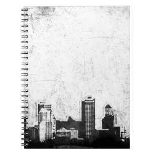 Grungy city background in black and white spiral notebook