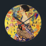 Gustav Klimt Lady with Fan<br><div class="desc">Clock featuring Gustav Klimt’s oil painting Lady with Fan (1918). A woman wearing a blue kimono holds a red fan against a colourful yellow background of flowers and peacocks. A great gift for fans of Japonisme and European art.</div>