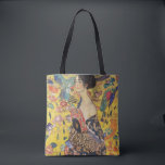 Gustav Klimt Lady With Fan Art Nouveau Painting Tote Bag<br><div class="desc">Gustav Klimt Lady With Fan Art Nouveau Painting This half portrait of a beautiful woman shows a yellow background with asiatic ornaments, colourful birds and lotus flowers. The lady wears a dress in the style of a kimono imprinted with motives of a Chinese dragon dress. Beautiful artistic romantic decorative fine...</div>