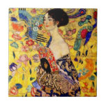 Gustav Klimt Lady with Fan Tile<br><div class="desc">Tile featuring Gustav Klimt’s oil painting Lady with Fan (1918). A woman wearing a blue kimono holds a red fan against a colourful yellow background of flowers and peacocks. A great gift for fans of Japonisme and European art.</div>