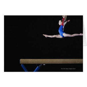 Gymnast (9-10) leaping on balance beam 2