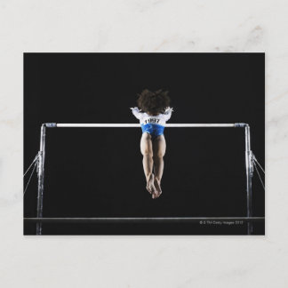 Gymnast (9-10) reaching for uneven bars postcard
