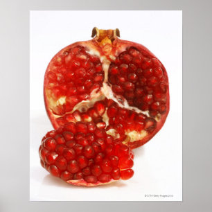 Half a ripe pomegranate cut to expose the juicy poster