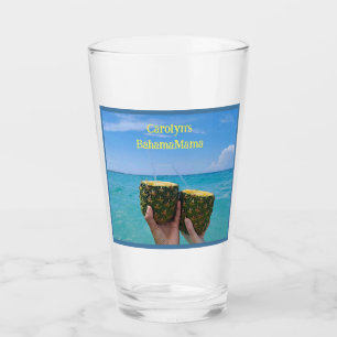 Half pineapples filled with punch, on the beach glass