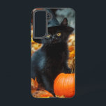 Halloween Black Cat and Pumpkin Samsung Galaxy Case<br><div class="desc">Samsung Galaxy Case featuring an adorable black cat wearing a witch’s hat! This little cutie poses with a pumpkin. Autumn leaves carpet the forest floor. A purr-fect gift for Halloween celebrations!</div>