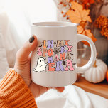 HALLOWEEN MAMA IN MY SPOOKY MOM ERA COFFEE MUG<br><div class="desc">Discover the ultimate blend of spook and sweetness with our Ceramic Cartoon Ghost Mug, featuring the whimsical phrase 'IN MY SPOOKY MOM ERA' in pastel tan, cream, pink, and violet hues. This groovy Halloween-style font adds a touch of retro charm to your collection. Adorned with classic Halloween decorations like skulls,...</div>