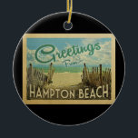 Hampton Beach Vintage Travel Ceramic Tree Decoration<br><div class="desc">This Greetings From Hampton Beach vintage postcard design features a sandy beach with a beautiful turquoise ocean water and above the sea,  a blue sky with billowy white clouds. In vintage travels style.</div>