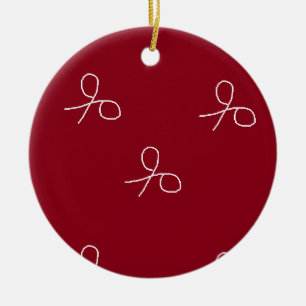 Hand drawn scissors on maroon red ceramic tree decoration
