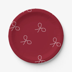 Hand drawn scissors on maroon red paper plate