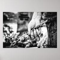 Hand holding a rose graveyard sculpture
