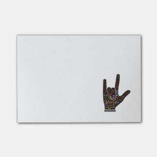 Hand with inspirational text post-it notes