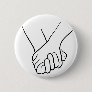 hands holding 6 cm round badge