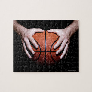 Hands holding a basketball jigsaw puzzle