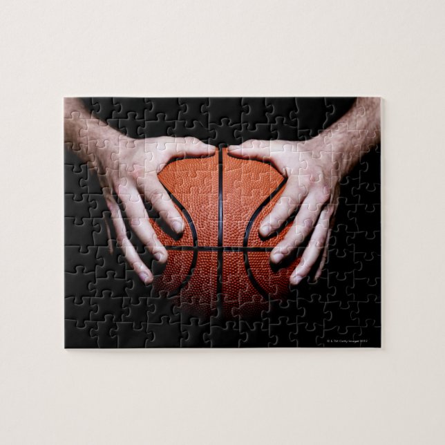 Hands holding a basketball jigsaw puzzle (Horizontal)