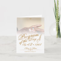 Hands of a coloured wedding couple pin on ring gol